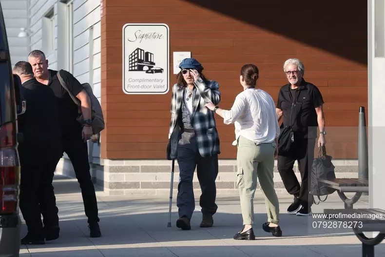 *EXCLUSIVE* Johnny Depp uses a cane while arriving in Boston for his Hollywood Vampires show after being forced to reschedule due to ankle fracture.