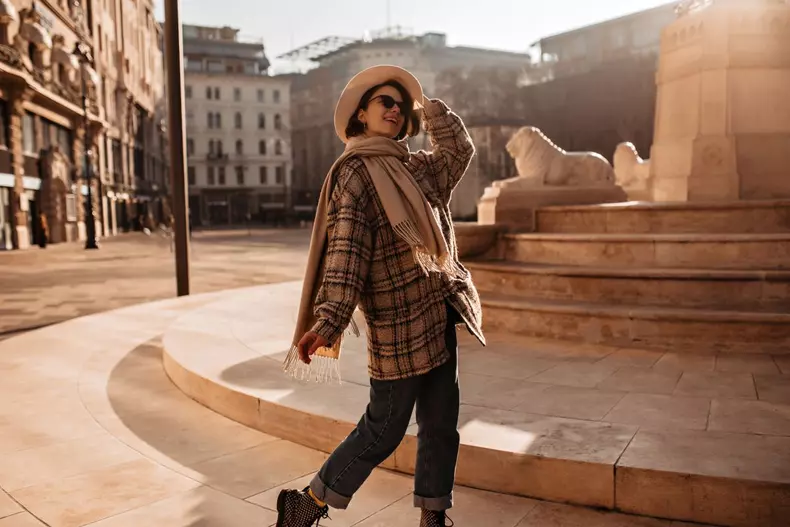 Excited,Woman,In,Oversized,Checkered,Coat,Smiles,And,Walks,Around