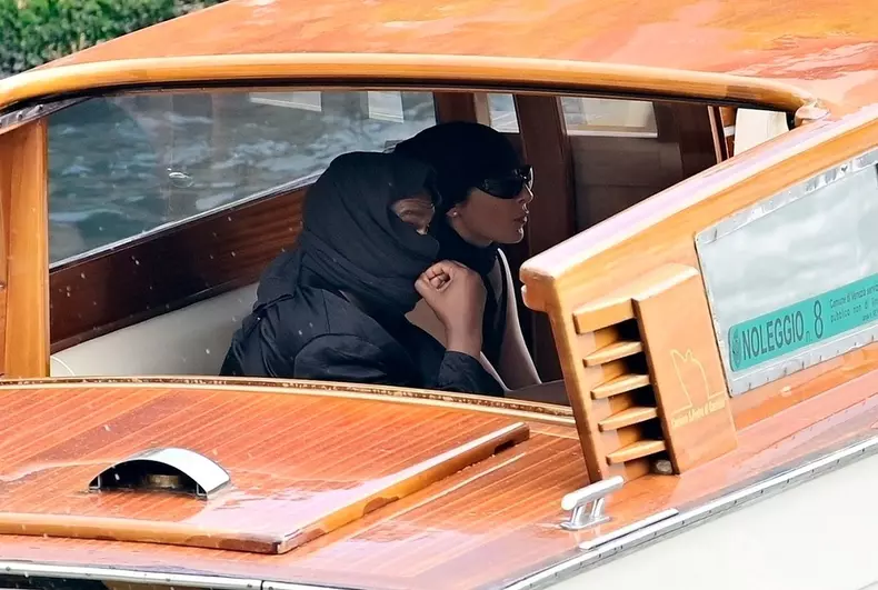 *PREMIUM-EXCLUSIVE* *MUST CALL FOR PRICING* Kanye West has a wardrobe malfunction as his rear end is on show to passing tourists as he takes a river taxi with his wife Bianca Censori on Venice's canal