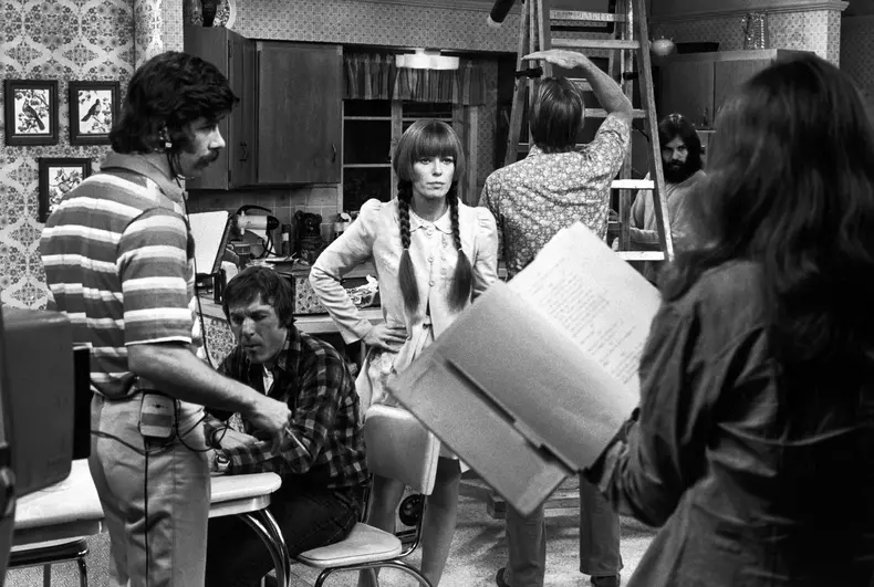 Production crew surrounding series star Louise Las