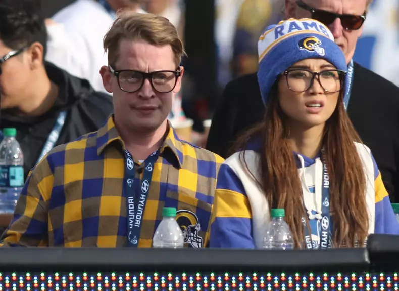 Actor Macaulay Culkin and Brenda Song attend the game between the Los Angeles Rams and the Arizona Cardinals at the Los Angeles Memorial Coliseum on December 29, 2019 in Los Angeles, California