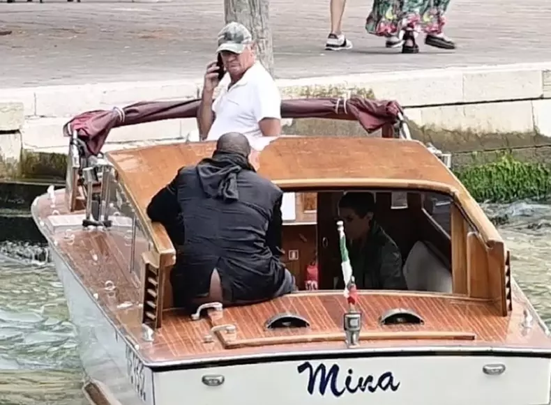 *PREMIUM-EXCLUSIVE* *MUST CALL FOR PRICING* Kanye West has a wardrobe malfunction as his rear end is on show to passing tourists as he takes a river taxi with his wife Bianca Censori on Venice's canal