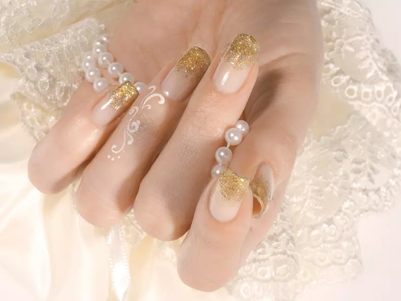 Woman's hand with golden manicure
