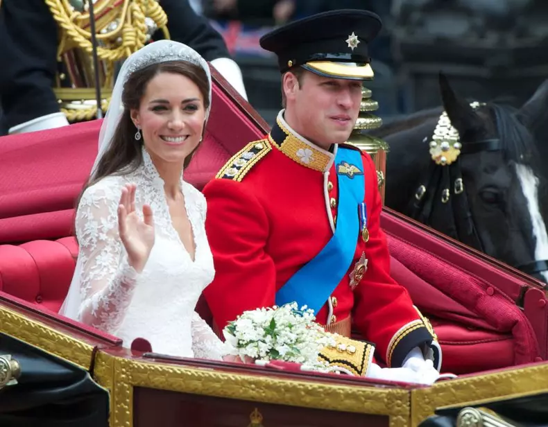 Kate and William ride a carriage from Westminster abbey to Buckingham Palace after getting married