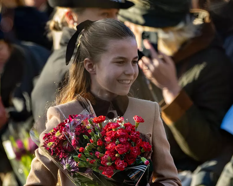25 Dec 2025. Sandringham, Norfolk UK. Princess Charlotte receives flowers from well-wishers on leaving St. Mary Magdalene Church on the Sandringham Estate after attending the Christmas morning service.