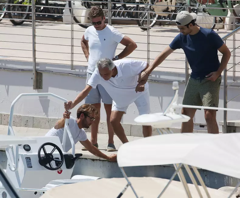 *EXCLUSIVE* Blind Italian operatic tenor Andrea Bocelli gets tender help from his son Matteo Bocelli to board a boat in Forte dei Marmi