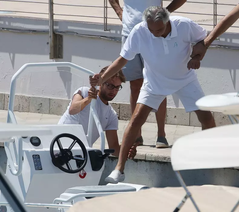 *EXCLUSIVE* Blind Italian operatic tenor Andrea Bocelli gets tender help from his son Matteo Bocelli to board a boat in Forte dei Marmi