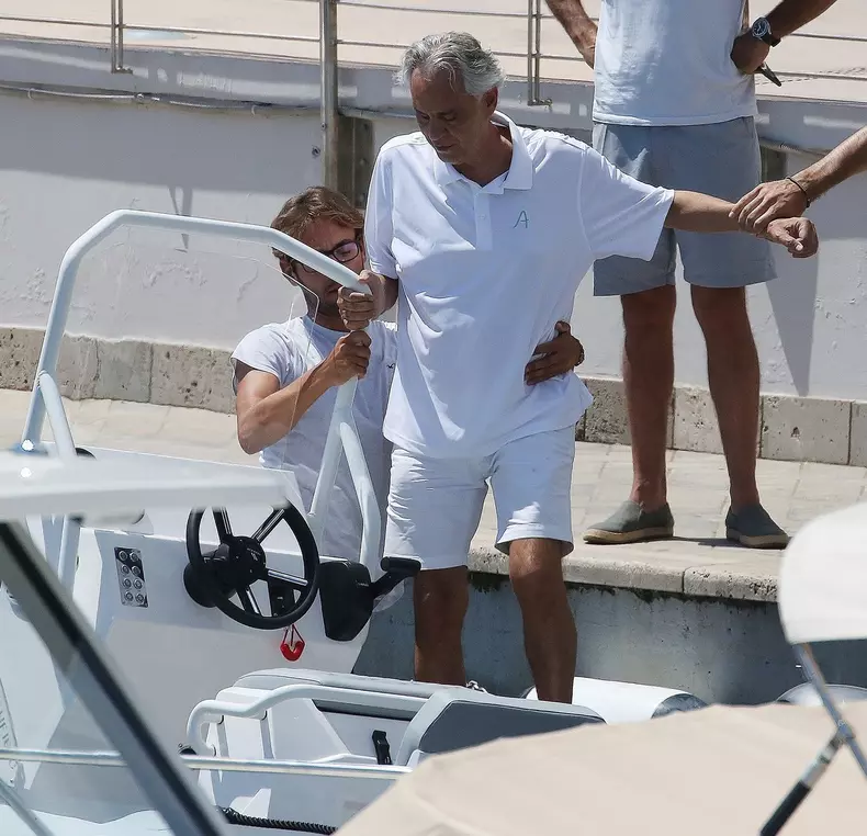 *EXCLUSIVE* Blind Italian operatic tenor Andrea Bocelli gets tender help from his son Matteo Bocelli to board a boat in Forte dei Marmi
