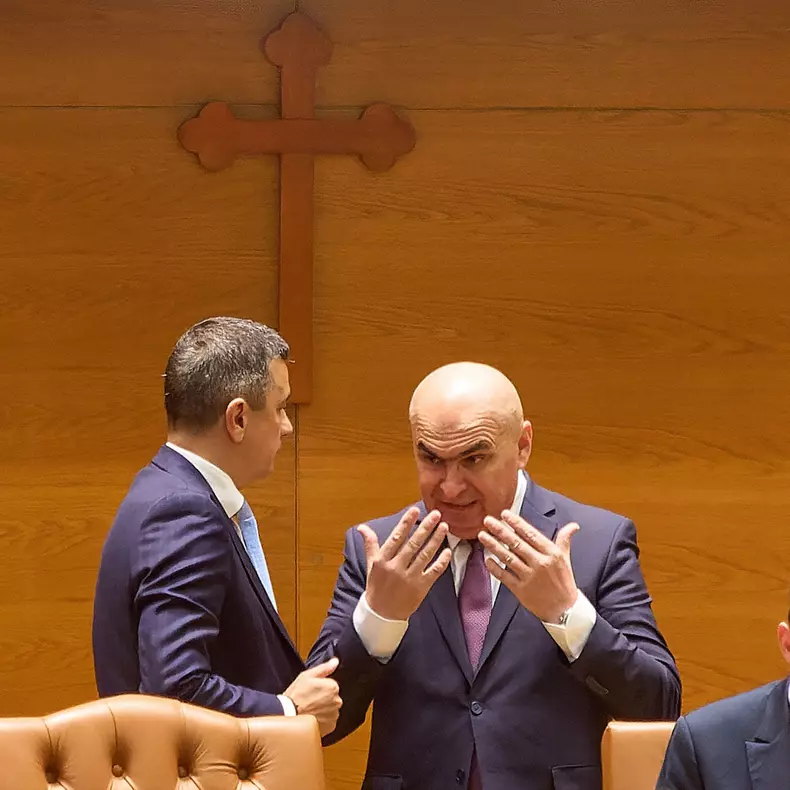 Bucharest, Romania. 1st Sep, 2025: Romanian Prime Minister Ilie Bolojan (R) speaks to Sorin Grindeanu (L), president of the Chamber of Deputies and interim president of the Social Democratic Party (PSD), during the joint plenary session of Parliament as t