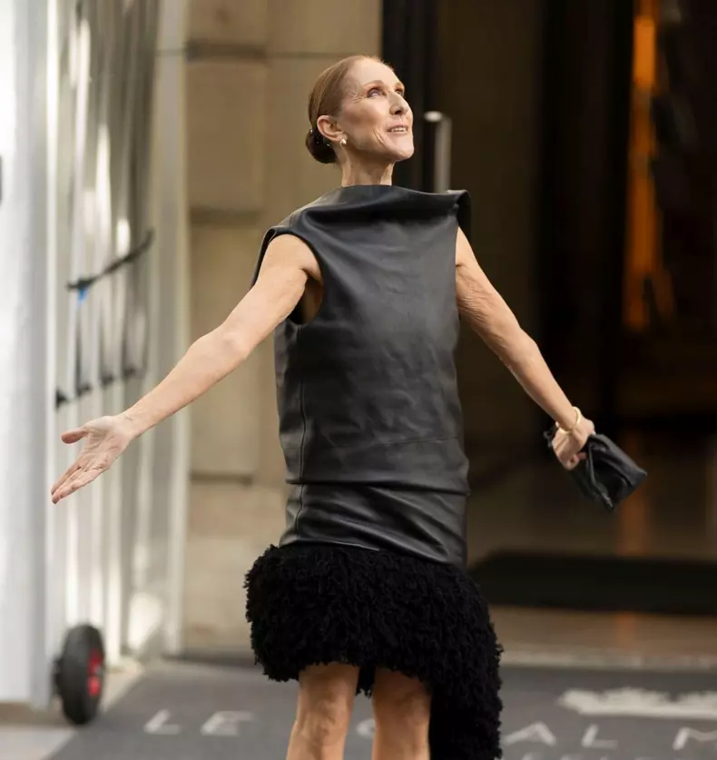 Celine Dion leaves her hotel and puts on a performance as she sings and dance for her fans in a stunning black dress out in Paris.