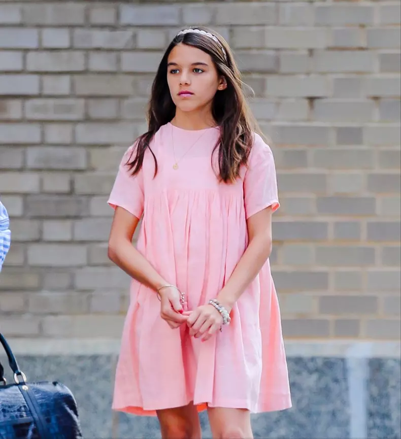 Suri Cruise wears a peach dress with matching lipstick as heading for a picnic in New York City