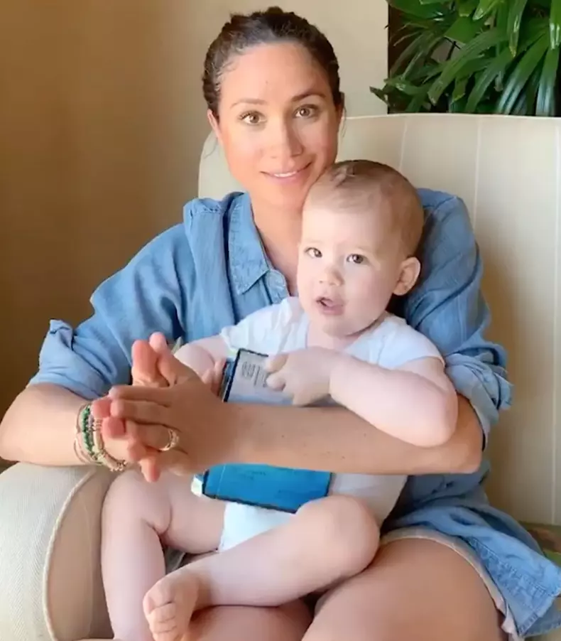 Meghan Markle reads baby Archie a story in a video released on his first birthday to raise money for children affected by coronavirus