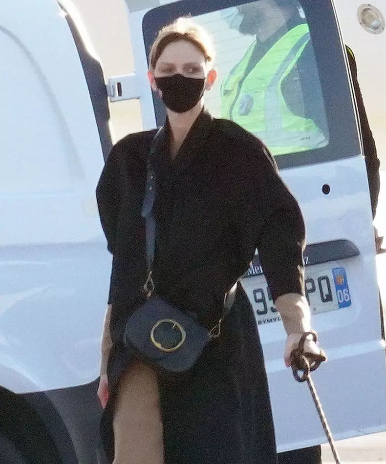 Princess Charlene of Monaco pictured on the tarmac at Nice airport walking the dog on her return after a ten-month stay in South Africa.