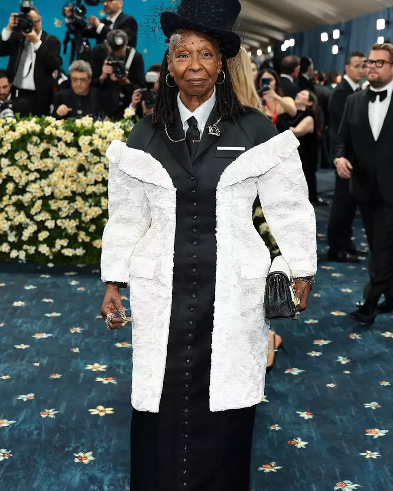 … whoopi …whoopi goldberg wears custom thom browne for the 2025 met gala. whoopi wears a black duchess satin raglan-sleeve tailored dress and a stacked matte white sequin overcoat, heavily embroidered w (1)