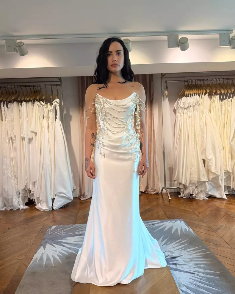 Demi Lovato and Jordan “Jutes” Lutes are officially married! The couple's wedding took place in California this weekend, with @ddlovato wearing a pearl-white, corseted @VivienneWestwood dress. “When I w (2)