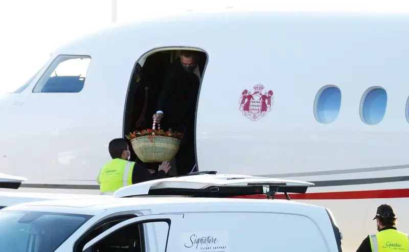 Princess Charlene of Monaco pictured on the tarmac at Nice airport walking the dog on her return after a ten-month stay in South Africa.