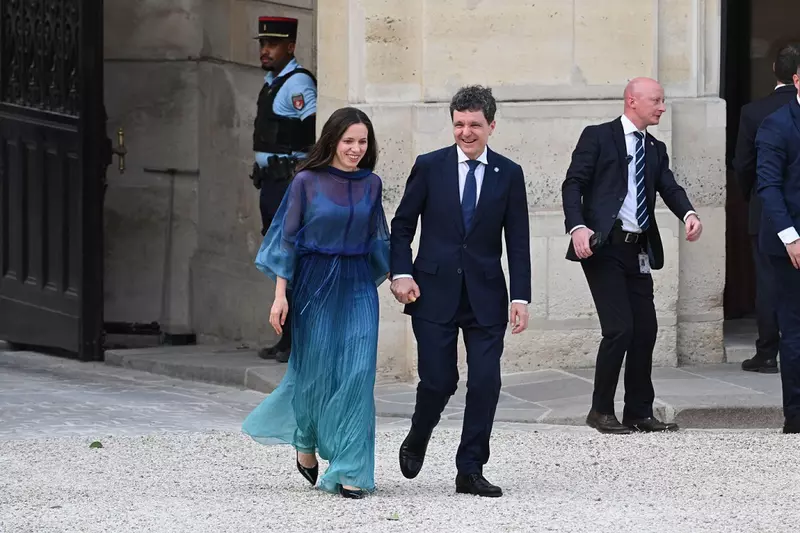 Paris, France. 13th July, 2026. Nicusor Dan, Romania's president, right, and his partner Mirabela Gradinaru arrive for a dinner of the Coalition of the Willing on Ukraine at The Elysee Presidential Palace in Paris, France, on July 13, 2026. Photo by Flori