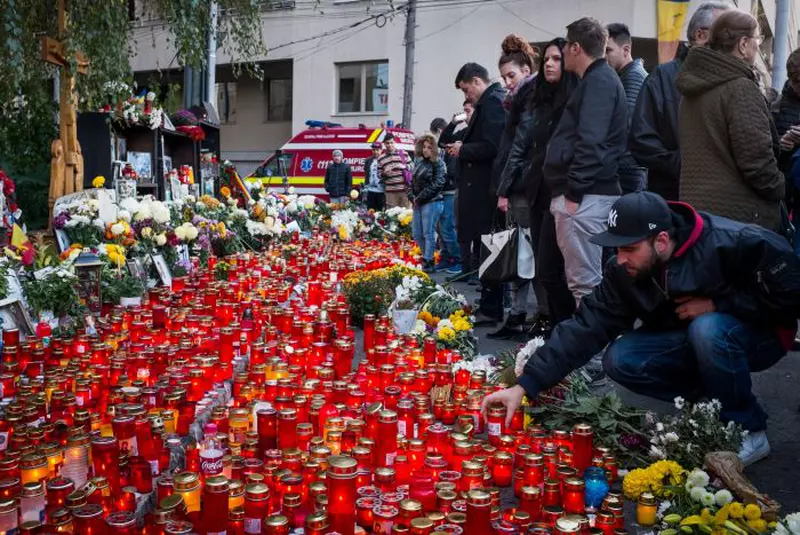 Persoane aprind lumanari la monumentul dedicat memoriei celor 64 de tineri ce si-au pierdut viata in incendiul din Club Colectiv, in Bucuresti, duminica, 30 octombrie 2016.